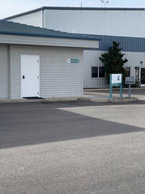The sign, mailbox, and part of building and parking lot of Steele Group Insurance Agency.