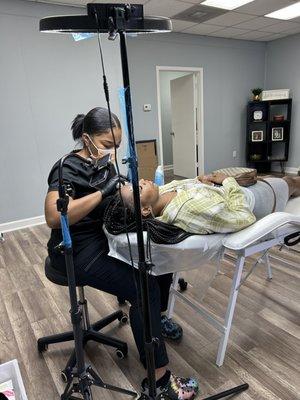 Artist working on clients eyebrows