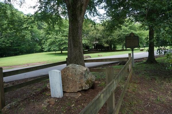 Chief McIntosh grave, log cabin in background