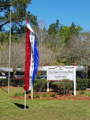 Our Now Leasing flag waves letting people know we have availability at our community!
