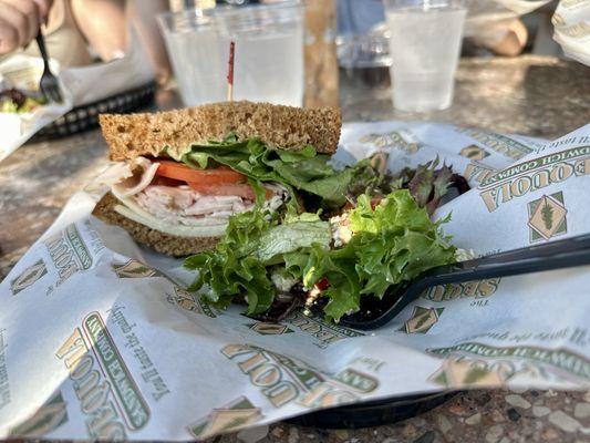 Cracked pepper turkey sandwich and some salad