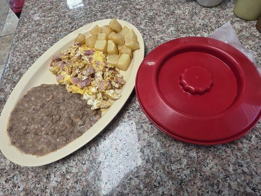 Breakfast plate with jam and eggs and potatoes