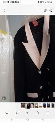 Jacket collar, pockets and buttons are PINK. Look at white dress next to jacket, clearly see the cleaners washed jacket with something RED.