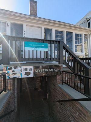 The door is down the stairs on the right.