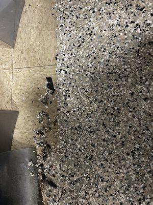 Messy application of epoxy flake floor under doorways.