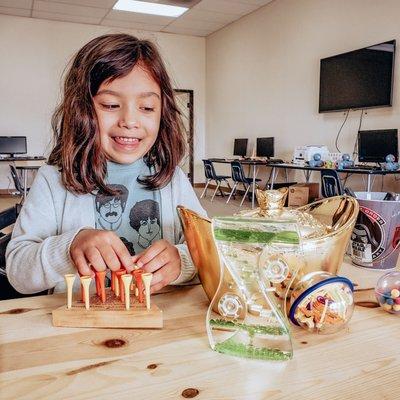 Sophie exploring their toys