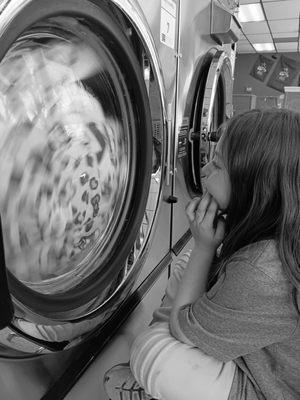 Meadow Maples of Longmont, 6, loves watching the washing machines at Soapy Jane's Laundromat in Longmont, Colorado.