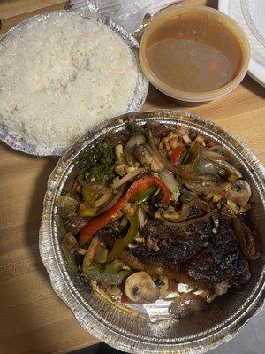 A burnt piece of steak, rice that's overcooked and smells/tastes burnt and beans.