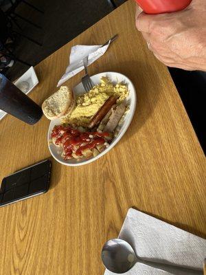 Eggs, fried potatoes, sausage and English muffin.