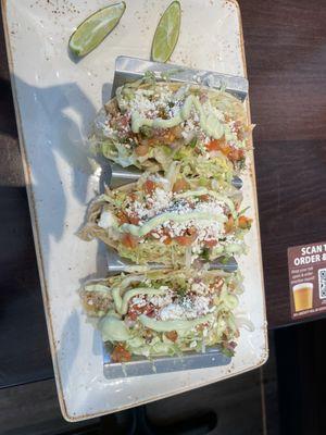 Chicken tacos (shredded chicken, lettuce and tomato, avocado crema, cotija)