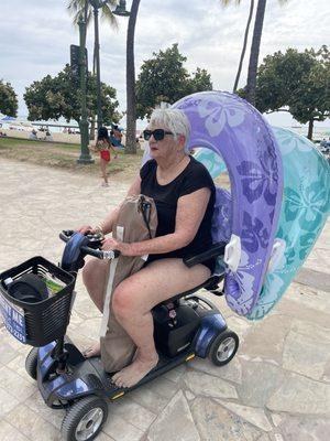 My mom and our beach gear on an Aloha scooter rental.