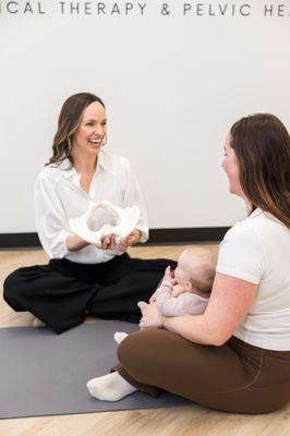 Dr. Jenn Gelfand teaching a client about pelvic floor and pelvic health at Root To Rise Physical Therapy in Scarborough, Maine.