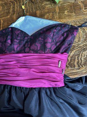 Missing flower. Pins are there but flower was ripped from the dress and stains when I picked the dress up. Ruined the dress.