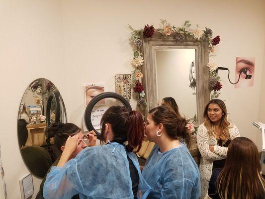 Students working together mapping eyebrows. I just love how serious they are.