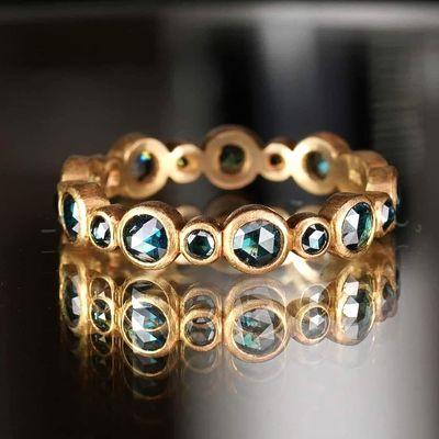 Brushed matte gold meets deep blue sapphires in this artisan-crafted eternity band. Bold and timeless.