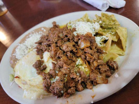 Chilaquiles w asada and over easy eggs