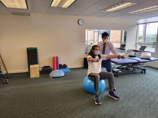 Lee Yek working with a patient on the stability ball!