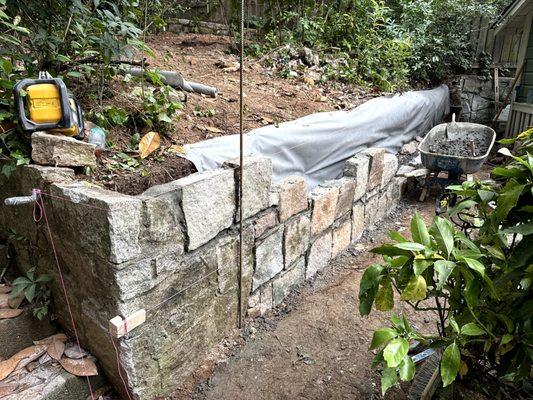 The new retaining wall being built.