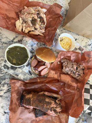 Pulled chicken, collards, sausage link sandwich, chopped brisket, Mac n cheese, ribs