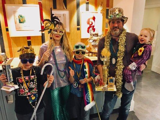 Luke and his family dressed top for the annual Mardi Gras Kids costume hosted by the Frame Shop