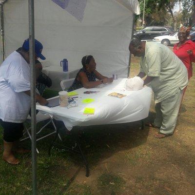 Registration table inside tent (LaFamilia chairs, tables, and tent)