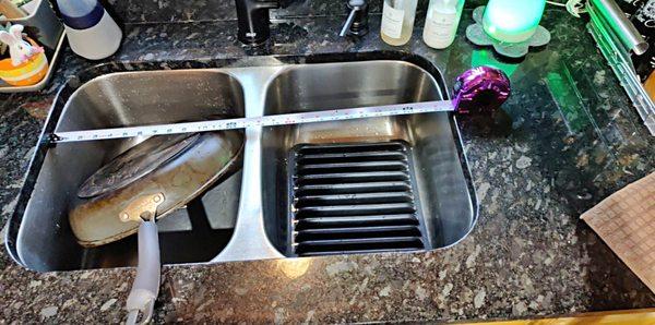 Hard to fill a pot, let alone wash a pan in this tiny sink (both sides equal size)... tiny