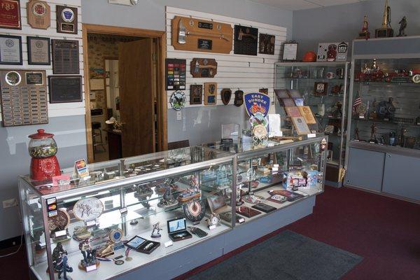 Inside our showroom, with various samples of awards we offer.