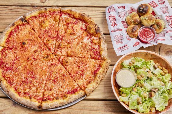 Family Meal with cheese pizza, garlic knots, and caesar salad.