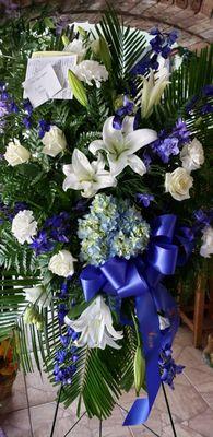 blue and white sympathy spray. 727 849 2222