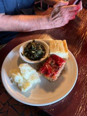 Meatloaf, mashed potatoes, mixed greens and cornbread.