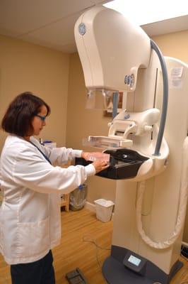 A technologist preparing a mammography machine.
