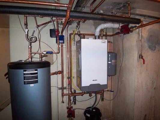 High efficiency boilers are very popular.  This provides heat for radiators and for the hot water tank beside it.