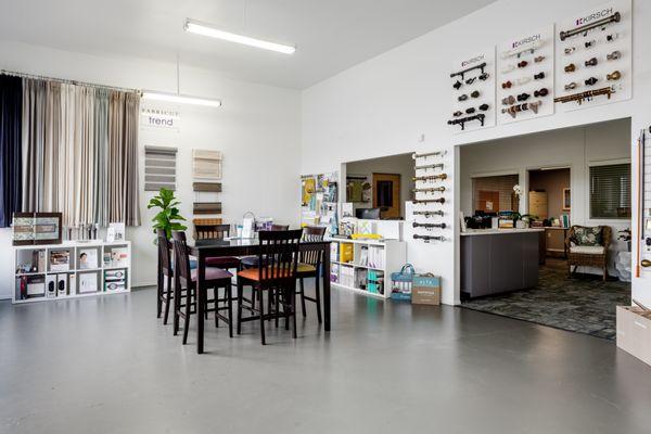Showroom features drapery hardware displays, window shades, blind and shutter sample books for check out (design trade only).