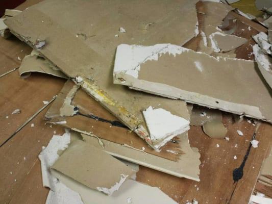 Water and mold damage on drywall in a basement.