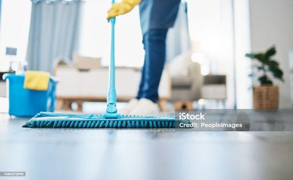Woman cleaning a hard floor.
