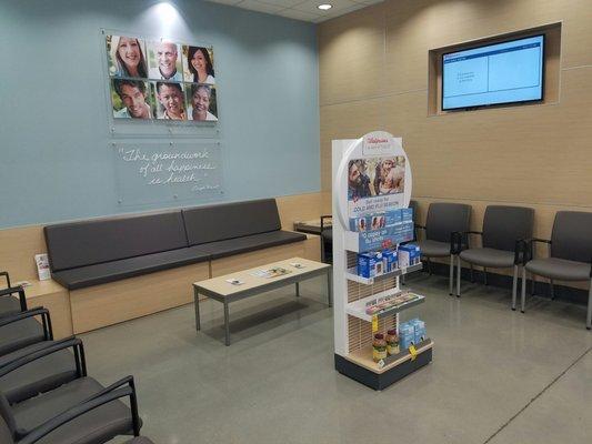 Pharmacy waiting area. Television screen lists prescriptions available.