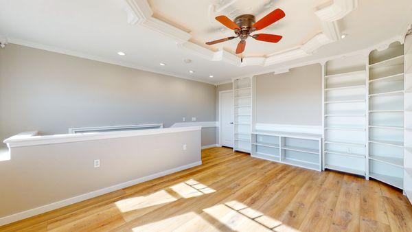 Large upstairs library with elegant crown moulding