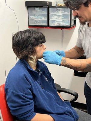 My daughter getting her piercing