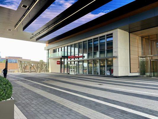 Outside / Exterior pic - on retail plaza level at Reston Wiehle Ave Metro Station - walk towards metro entrance under giant screen