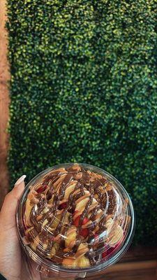 Pitaya bowl with strawberry, banana, pineapple, granola, peanut butter, Nutella