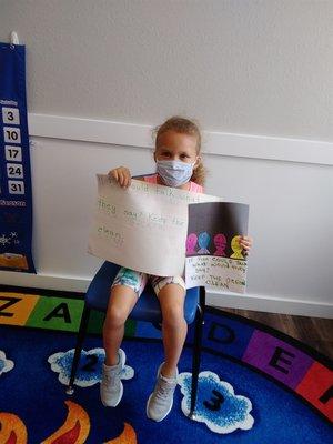 One of our students is telling a story to her friends about her project she made.