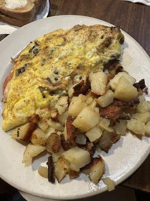 Swiss cheese and veggies omelette with home fries