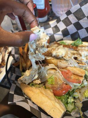 Very small amount of chicken on top of sub , set up to deceive the customer- loaded with toppings in the bottom of the sub roll