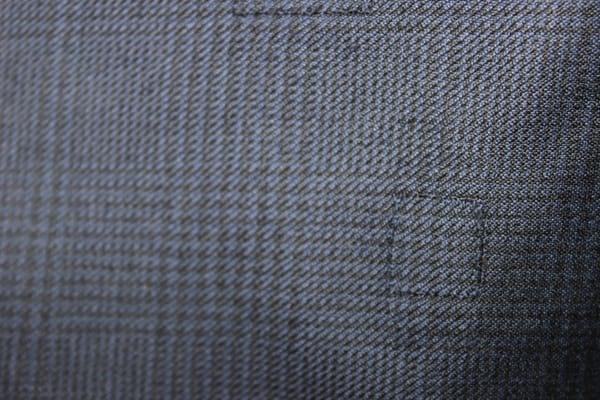 Reweaving work performed by Pacific Alterations. Note the reweaving "patch" on the lower right corner.