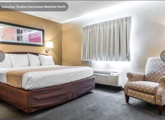 This is what the hotel wants you to believe you are getting. Look at that nice carpet and chair to sit in. Nice wall lamps and artwork too.