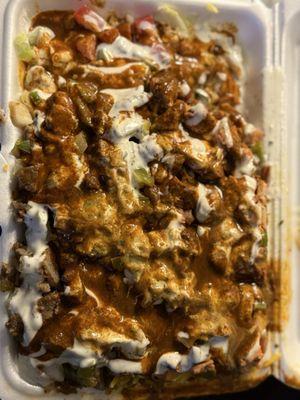 Lamb, chicken, yellow rice, tomatoes, shredded lettuce, white sauce, spicy sauce.