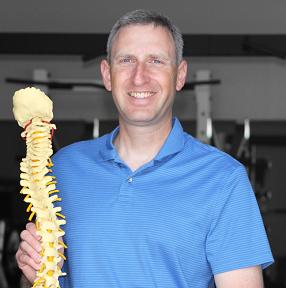 Dr. Maxeiner carrying a display spine. No, he does not always walk around with a plastic spine but it is a nice prop for the pic.