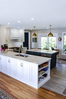 A lakeside kitchen with a custom wood hood, inset shaker doors and functional island...