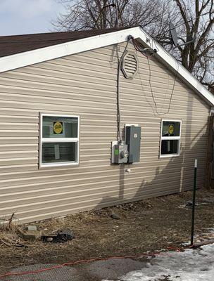Siding and window replacement completed after fire damage, restoring a clean and durable exterior.