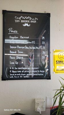 24 for a regular hair cut. Kids and senior discount. They do a face shave as well.